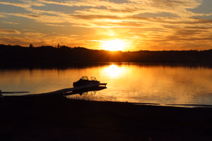 Sunset in mid August. Looking across the lake towards the boat launch.