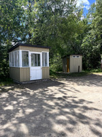 Fish filleting shack and outhouse at boat launch.