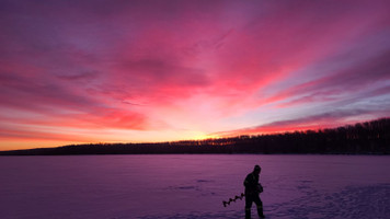 Winter ice fishing and camping on the lake 