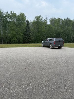 Parking lot just off the highway with a trail down to the lake.