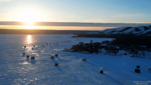 Sunset at Crooked Lake and the ice fishing shacks in the Qu'appelle Valley south of Grayson and Melville, Saskatchewan.