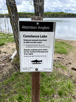 Sign describing custom trout limit on the lake.