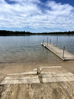 Cement boat launch with dock.