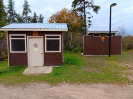 Fish cleaning shack and outhouse by the boat launch.