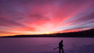 Winter ice fishing and camping on the lake 